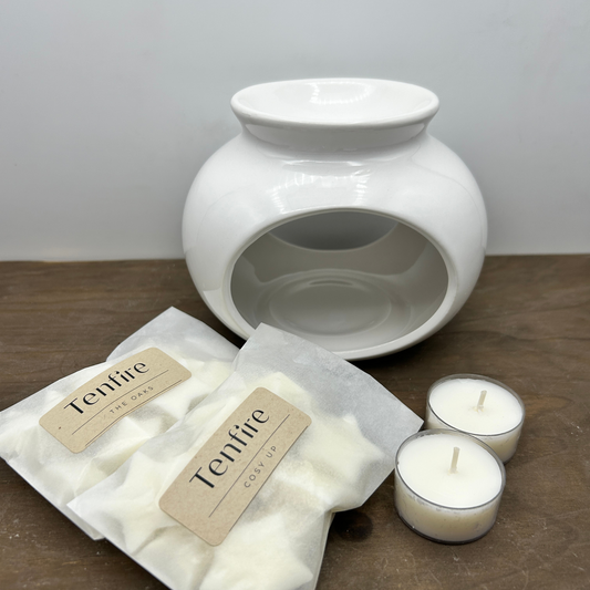round wax melt burner with two bags of wax melts and tea lights