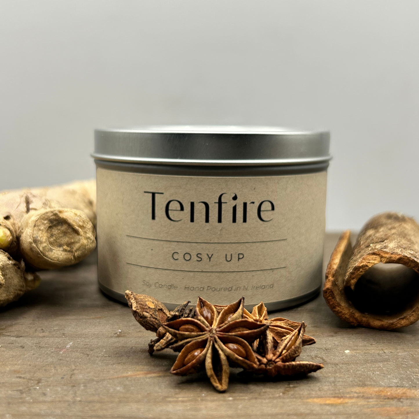 candle tin called cosy up with ginger, star anise and cinammon pieces around