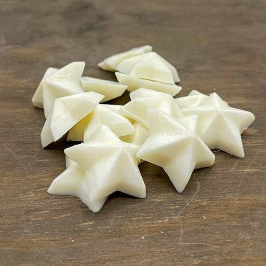 vegan soy wax wax melts in the shape of stars on wooden board